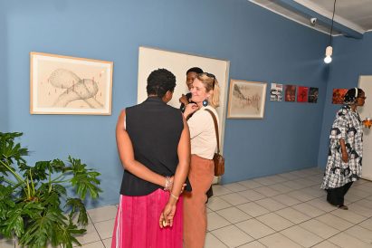 Two people talking in the new gallery at Native Rebels during Kasiology festival