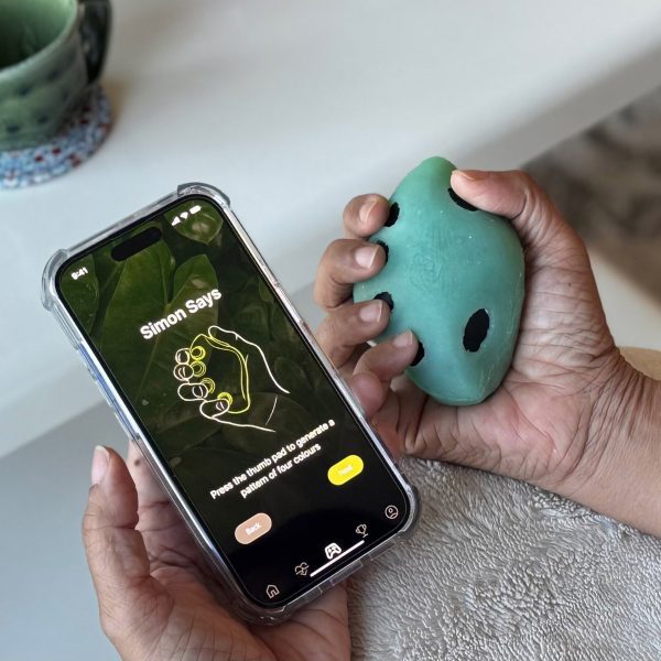 a photograph of a person holding a phone and a movement device
