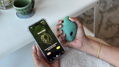  a photograph of a person holding a phone and a movement device