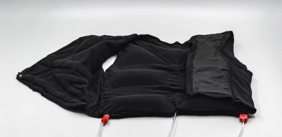 a photograph of a black vest garment laid flat