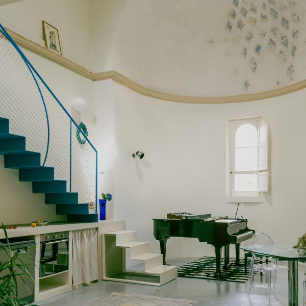 Piano, staircase and apse in Pailunga converted chapel by Atelier Vago