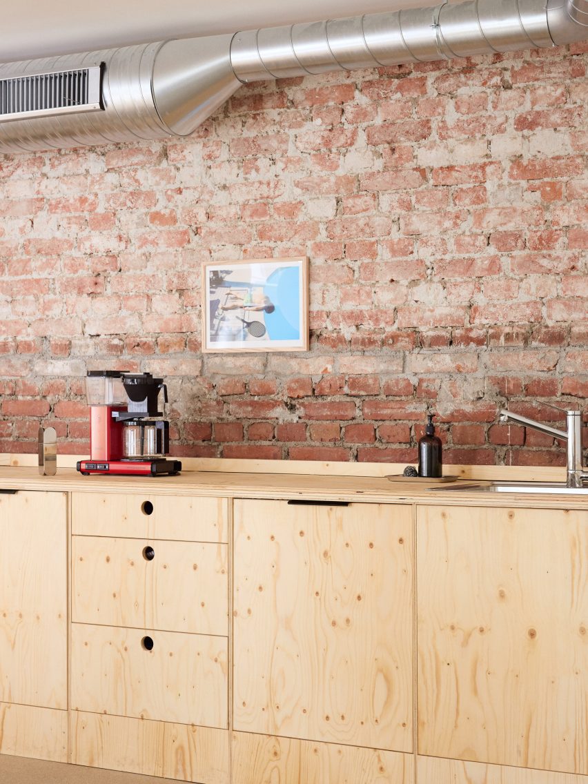 Wooden furniture and brickwork at Podimo Norway office by Omhu Projects