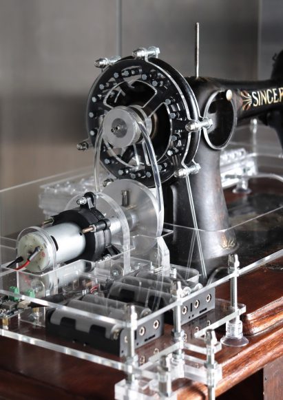 Close-up photo of the fly wheel on a modified Singer treadle sewing machine