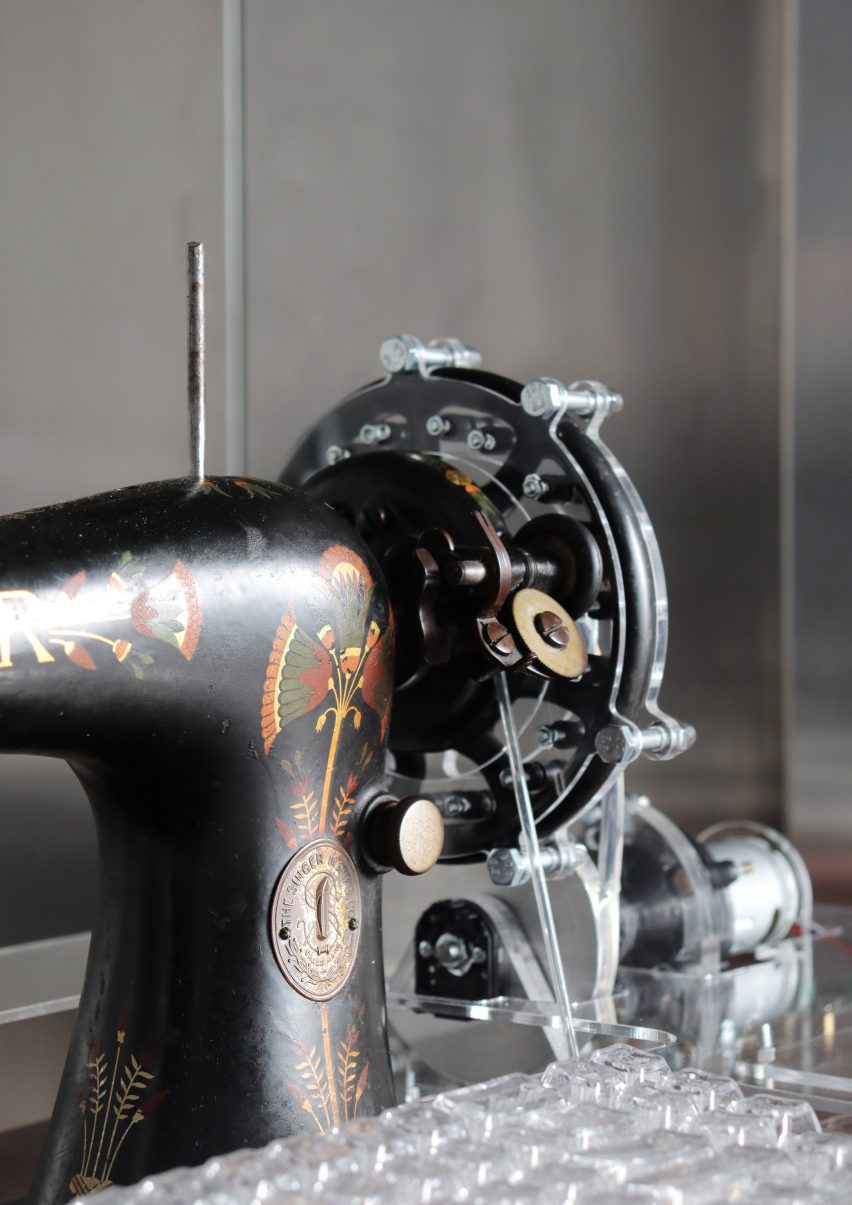 Close-up photo of a modified vintage Singer treadle sewing machine now with steampunk elements including a transparent plastic keyboard