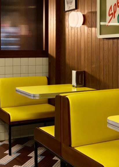 Yellow booth seating with yellow and stainless steel tables