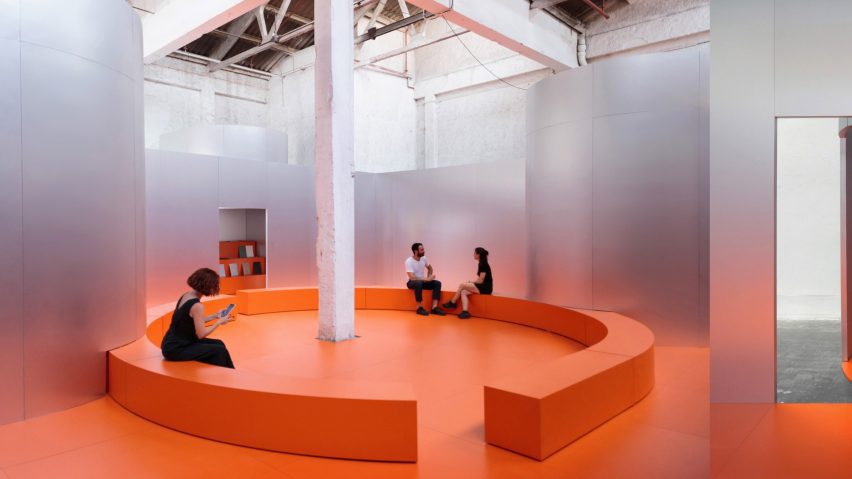 an image of an interior space in tones of orange and silver