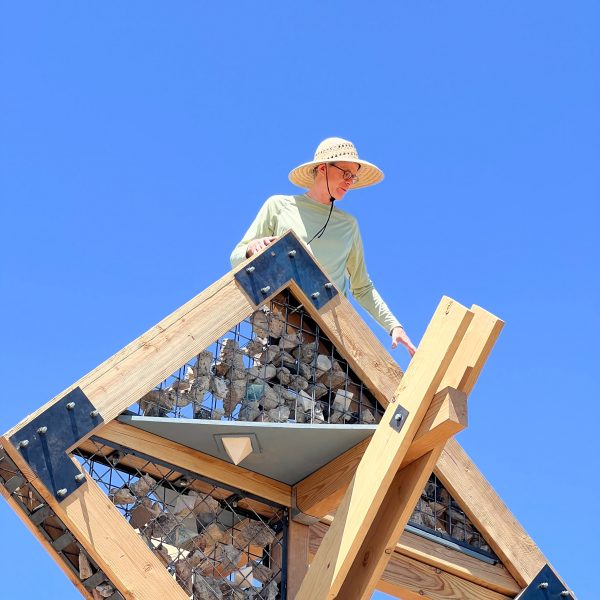 a photograph of a person on a wooden structure