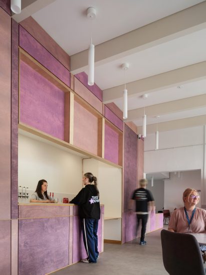 Purple plywood reception and bar inside Take A Bow centre