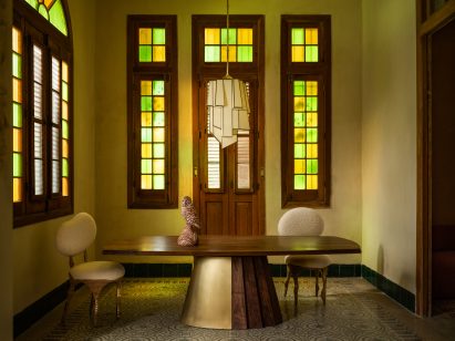 A room with stained glass windows featuring collectible designs by Anthony Guerrée, Chris Wolsten and Jason Koharik