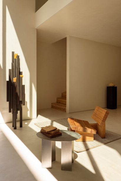 Wooden chair and metal sidetable in The Collector's Residence by Luso and The Modern Spaces