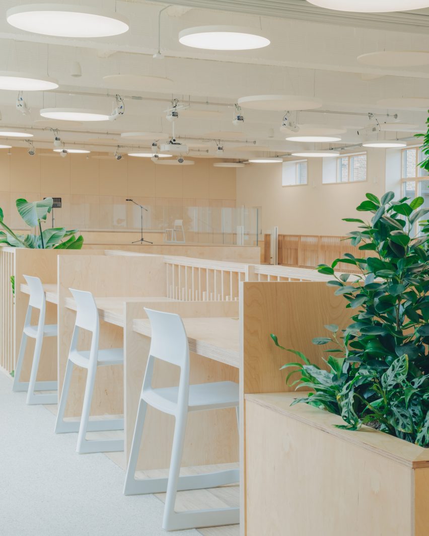 Fixed desks placed around perimeter of converted swimming pool