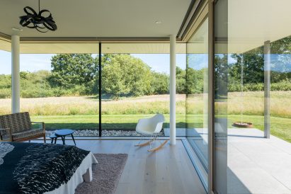 Glazed interior of Three Oaks Farm in West Sussex by Nick Willson Architects