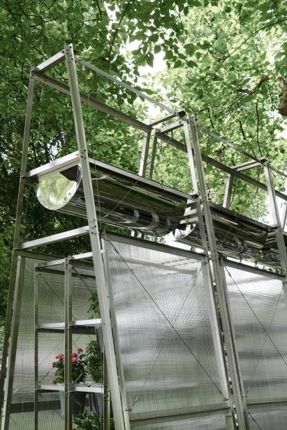 Close-up of water troughs on top of polycarbonate greenhouse