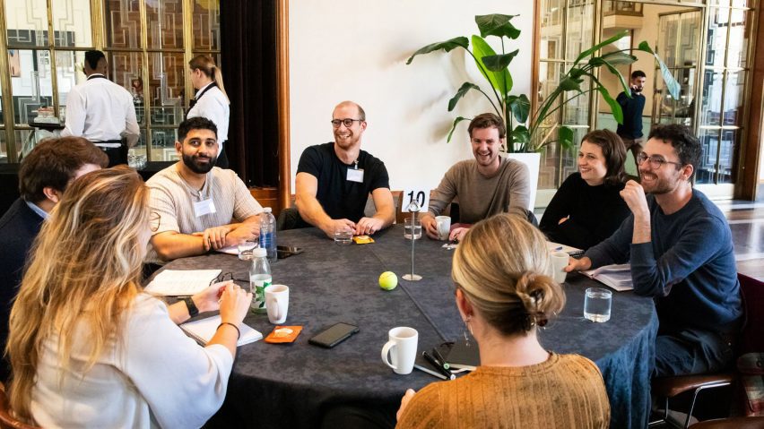 Photo of people sat around a table