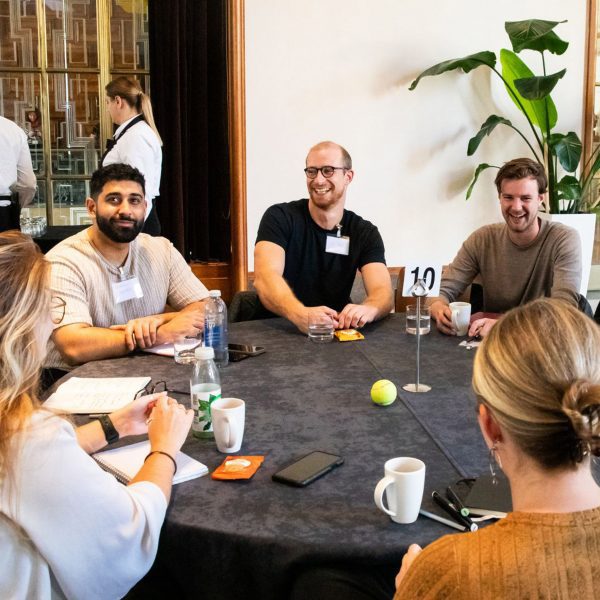 Photo of people sat around a table