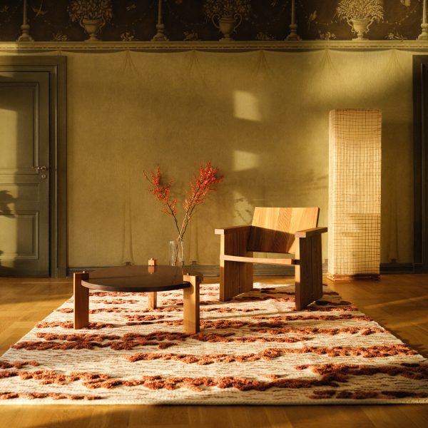 Photo of a wooden chair and table on a rug