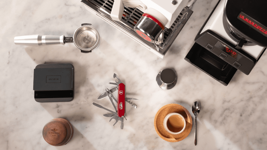 Coffee related items and Victorinox barista tool arranged on table
