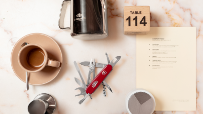 Barista tool on table next to other coffee related items