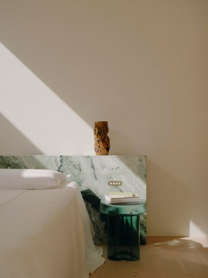 Bedside area with green glass table