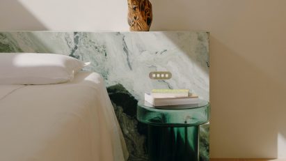 Bedside area with green glass table