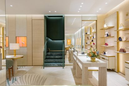 Boutique with palm fronds across the floors and woven textured walls