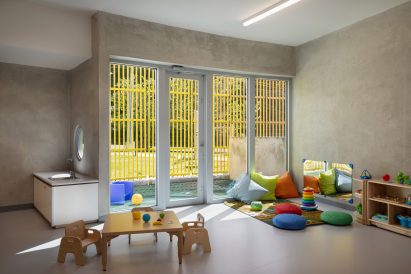 Classroom with glass doors leading out to a louvred play area