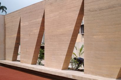Bench alongside tennis court at the Backyard Community Club by DeRoche Projects
