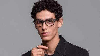 Portrait photo of a man staring into the camera wearing Even Realities G2 smart glasses and the R1 smart ring