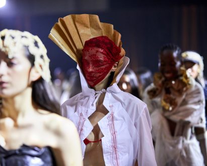 a model wearing a red head garment