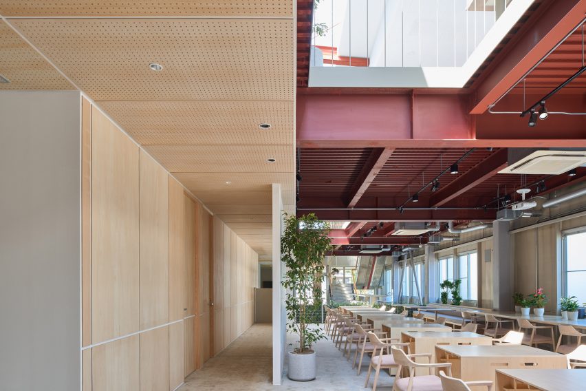 Timber wall panels and red painted beams