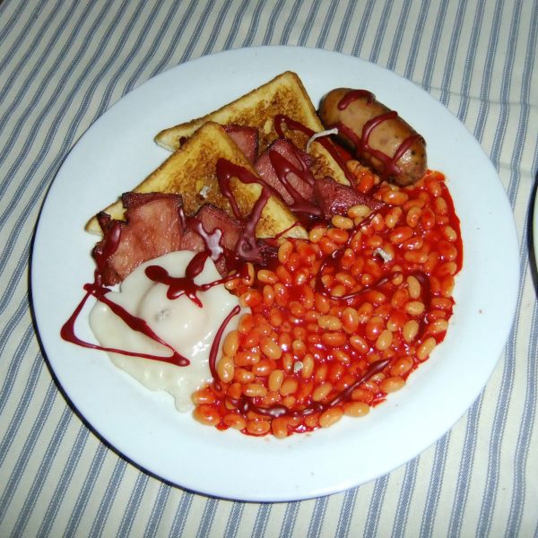 a candle that is a replica of a full english breakfast