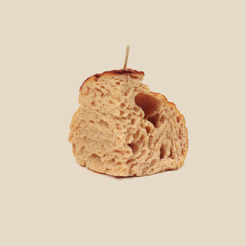 a photograph of a candle that is a replica of bread