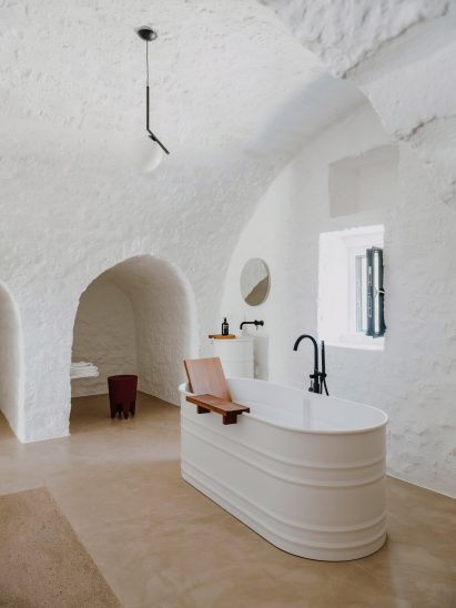 Bathroom in vaulted room with white bathtub