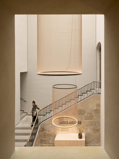 High-ceilinged hotel foyer with statement pendant lights hanging