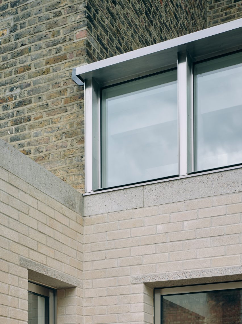 Stone bricks and stainless steel windows in Stone and Steel House extension by DGN Studio and Sarah Izod