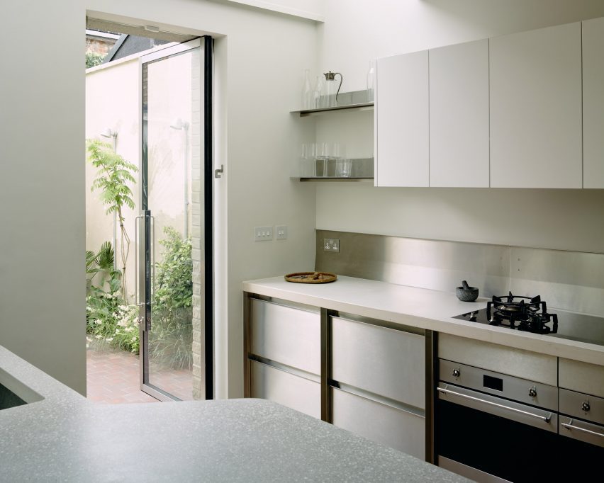 Kitchen in Stone and Steel House extension by DGN Studio and Sarah Izod