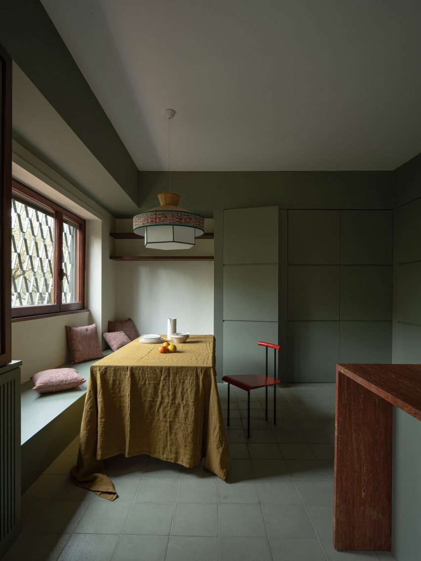 Mint-green kitchen with casual dining table in revamp of 1960s villa by StudioTamat