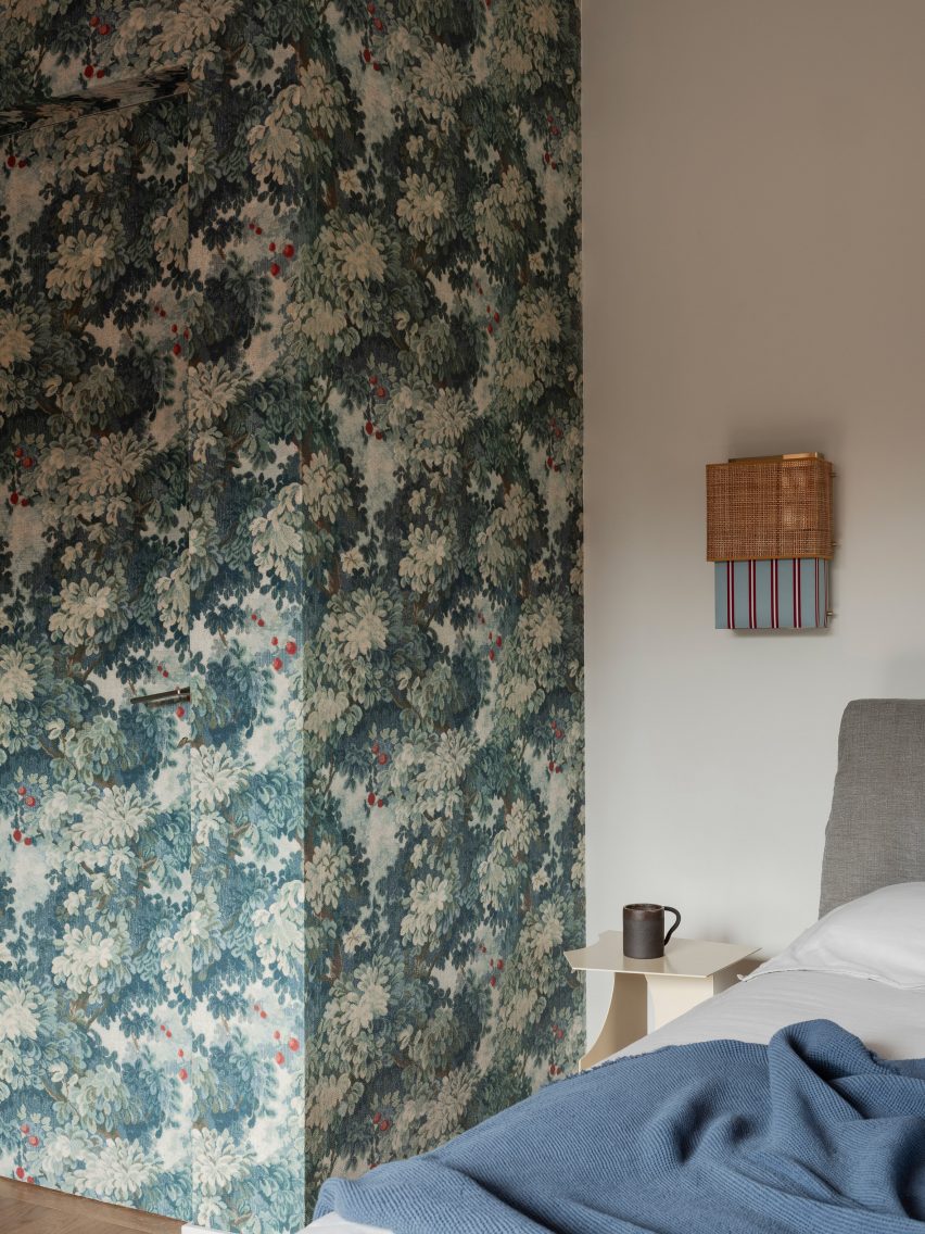 Bedroom with wallpaper in revamp of 1960s villa by StudioTamat