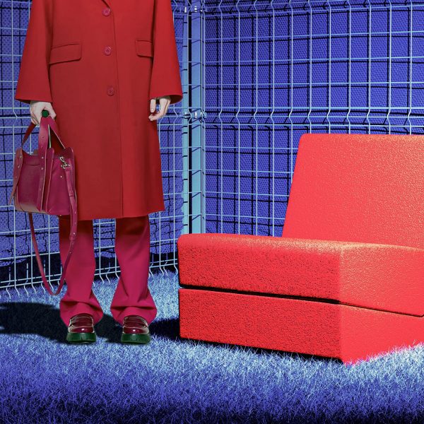 Graphic image of red chair and person wearing red coat, shoes and trousers