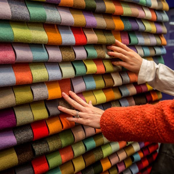 Photo of hands touching material samples