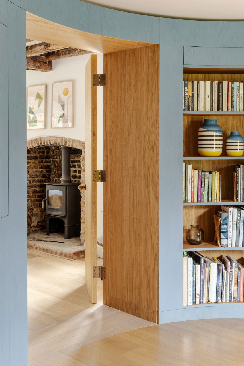 Library leading through to living room with fireplace