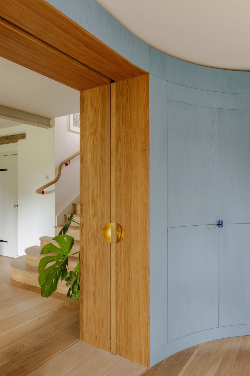 Curved wooden wall with secret drinks cabinet