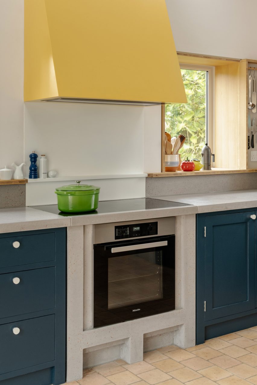 Oversized yellow extraction hood above cooker