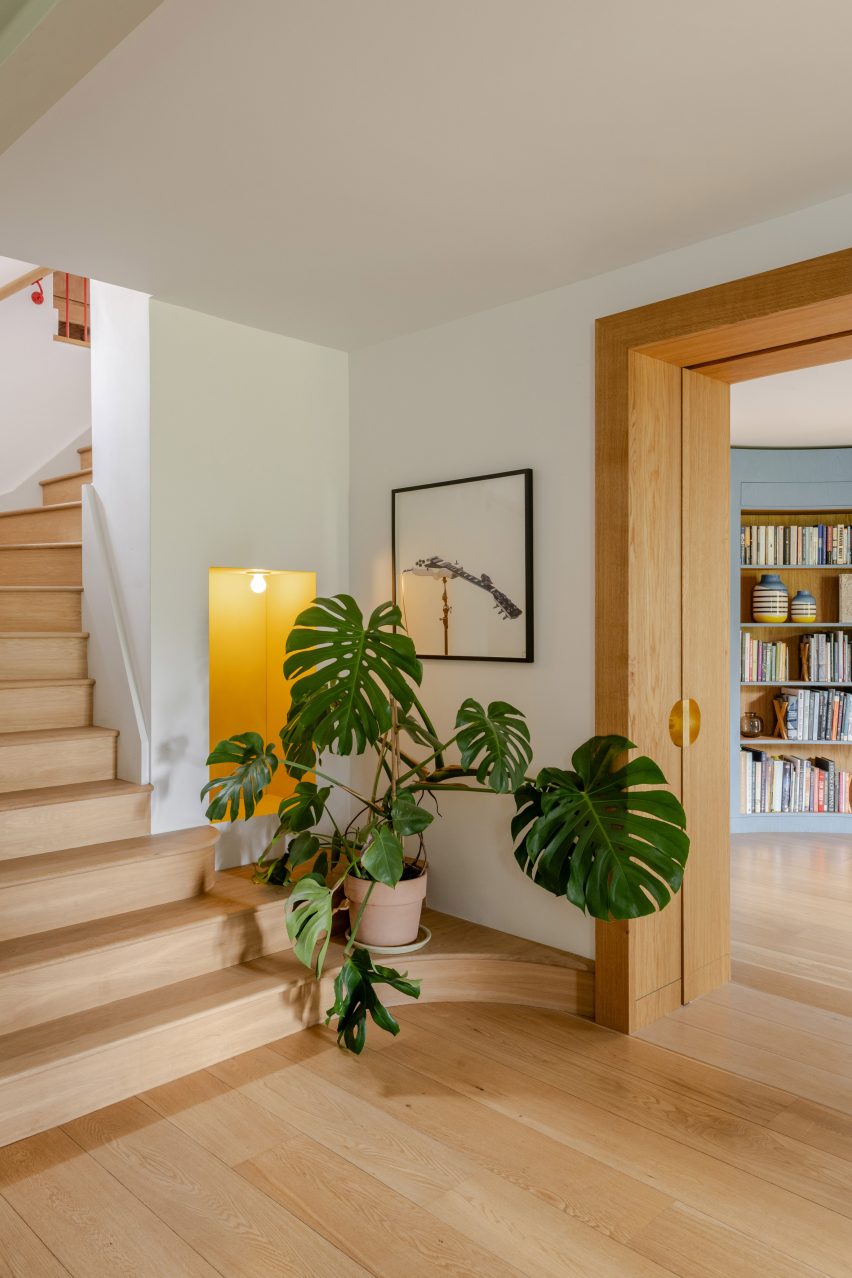 Hallway with wooden staircase and wall cutout