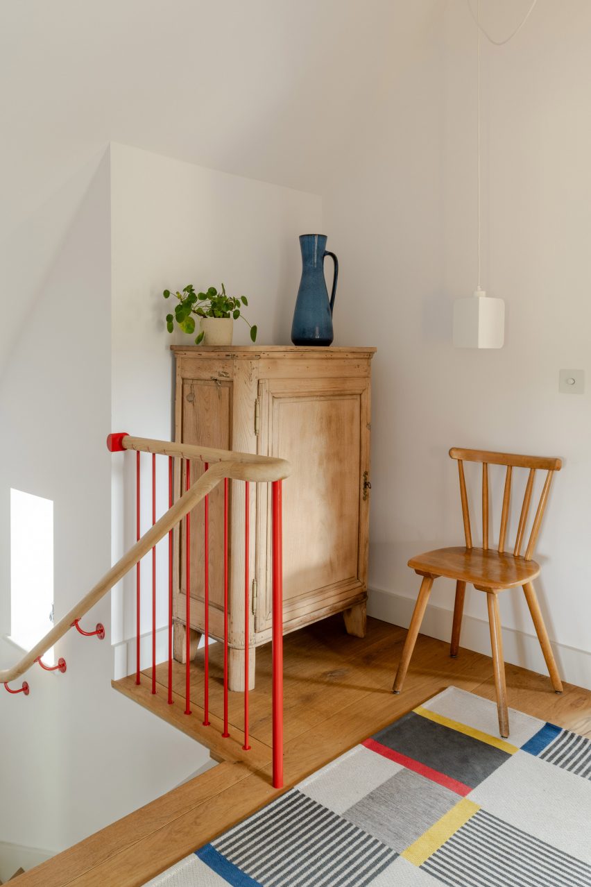 Kent house bedroom with timber and red staircase