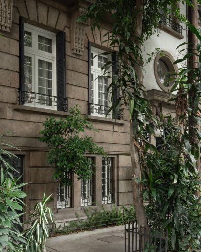 Exterior of a townhouse with a stone facade designed in an ornate French style