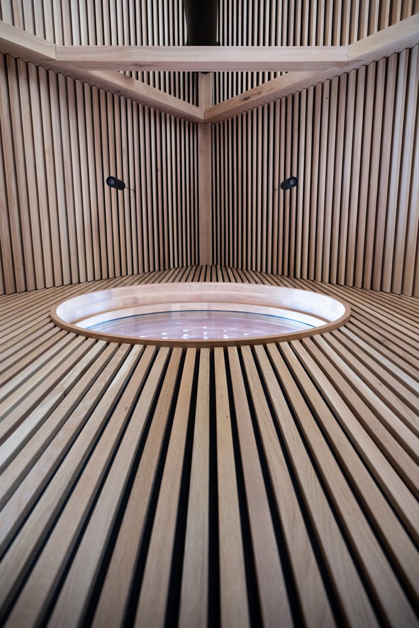 Circular window cutout in timber-clad wall
