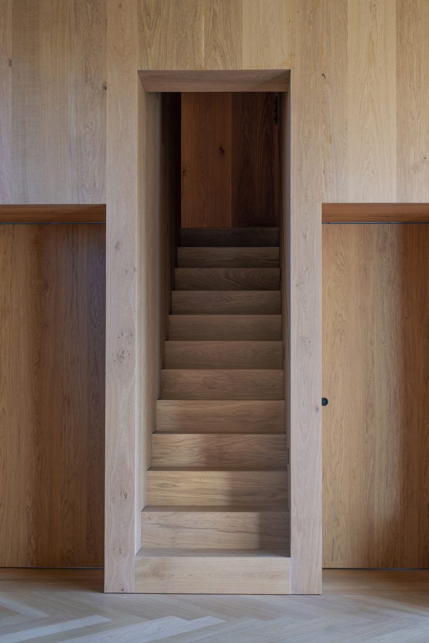 Staircase cut into oak-lined wall