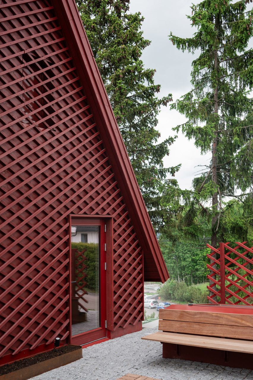 Red house extension next to forest