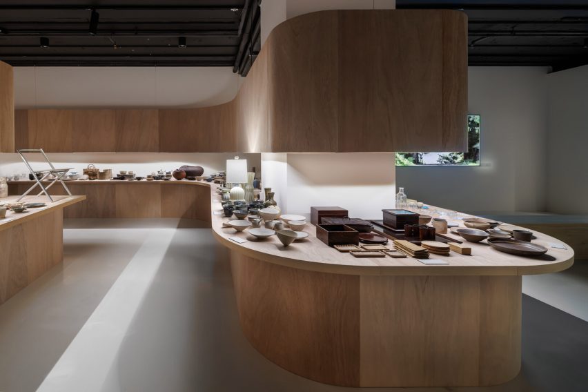 Undulating wooden tables covered in craft